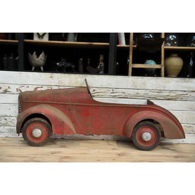 Original red patina sheet metal children's car from the 1930s