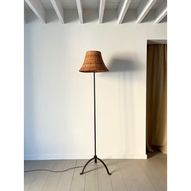 A vintage metal floor lamp of simple unadorned design, overpainted in brown. This iron standard light has a sturdy tripod...