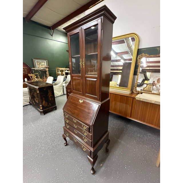 Beautiful vintage cherry Georgian Court Secretary desk by Ethan Allen. It features two-piece construction, beveled glass,...