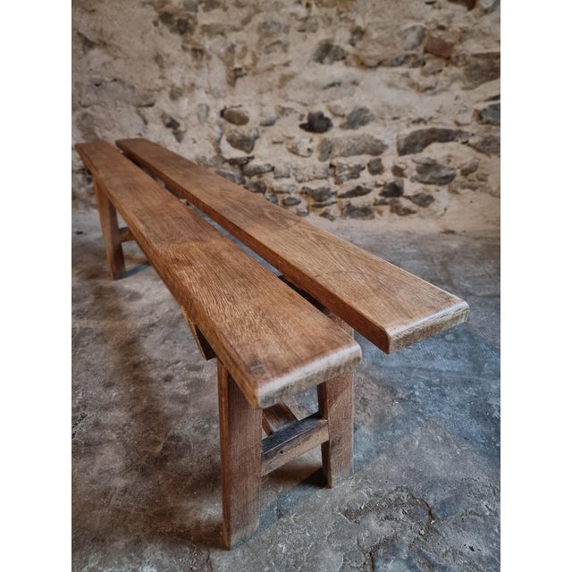 This French oak bench dates from the 1950s and features a simple and functional design typical of mid-20th century rural...