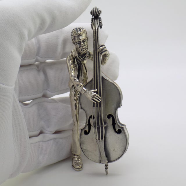 Large and rare vintage solid silver figurine depicting a cellist performing with his instrument, handcrafted in Arezzo,...