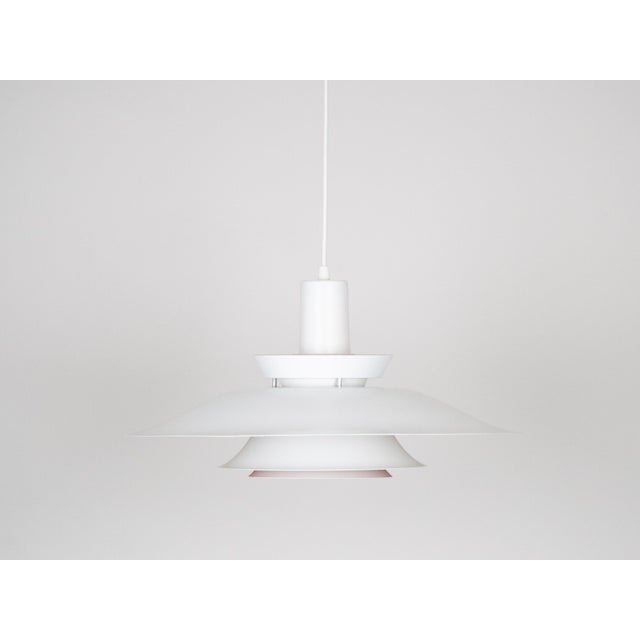 The lamp's form was designed based on the principle of a reflective system that directs light not only downward but also...