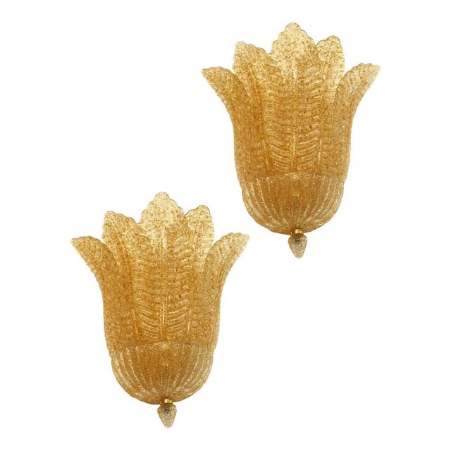 Classical venetian wall sconce, made in trasparent and gold “graniglia”. The glass worked in a slab an artisanal technique...