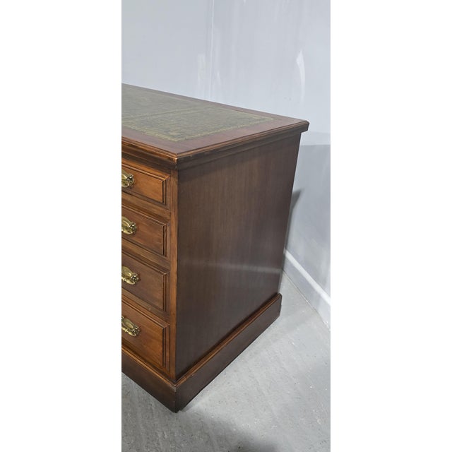 A good mahogany nine drawer pedestal desk, with brass handles and green leather top, in very good condition throughout....
