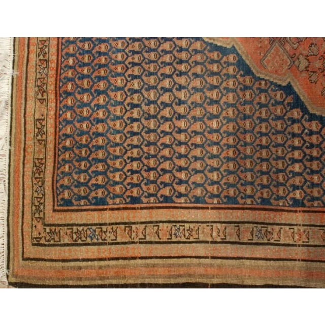 An antique Persian Malayer rug with beautiful central diamond medallion amidst a densely woven field of paisley patterns,...