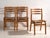 A set of three antique dining chairs in beech and moulded plywood, with a three-rail shaped back and a press-formed saddle...