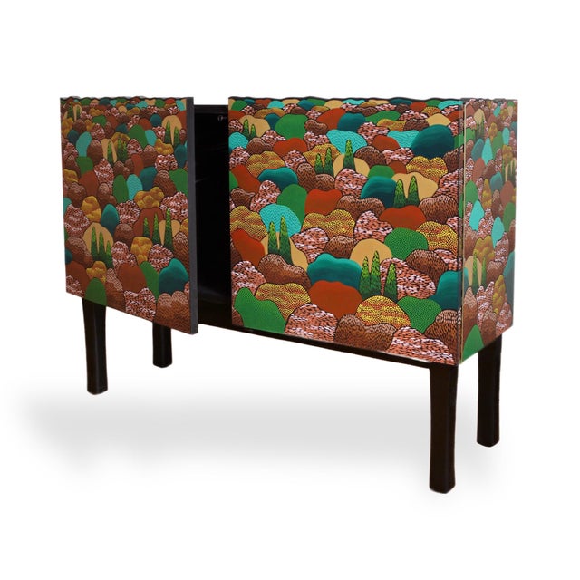 A beautiful cabinet hand carved and painted in greens, rusts and gold, inspired by the colours of the Provençal...