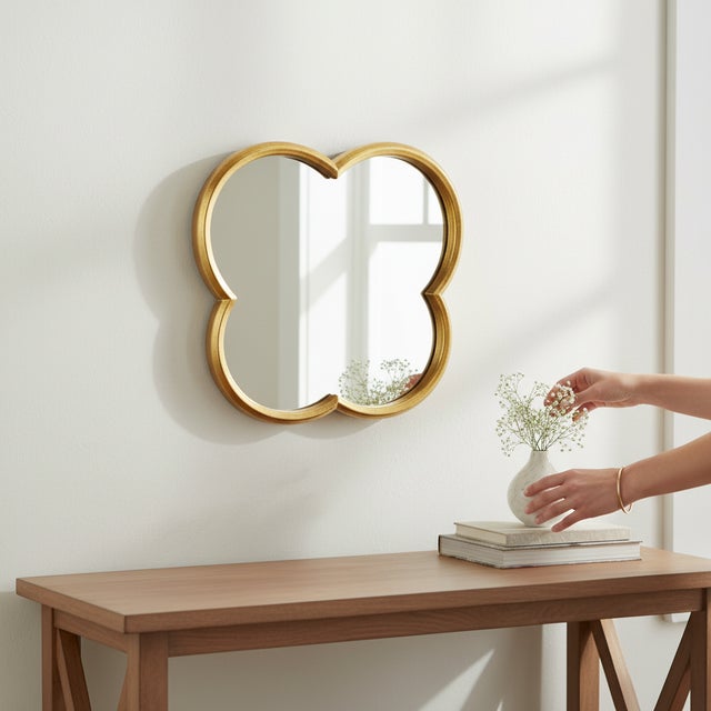 An elegant mid-century modern style gilt iron mirror in a four-leaf clover form, inspired by the iconic Alhambra...