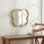 An elegant mid-century modern style gilt iron mirror in a four-leaf clover form, inspired by the iconic Alhambra...