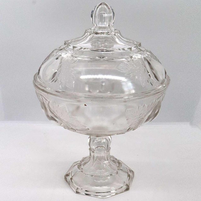 DETAILS This early American clear pressed glass (EAPG) round serving bowl with lid is raised on a tall standard and...