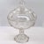 DETAILS This early American clear pressed glass (EAPG) round serving bowl with lid is raised on a tall standard and...