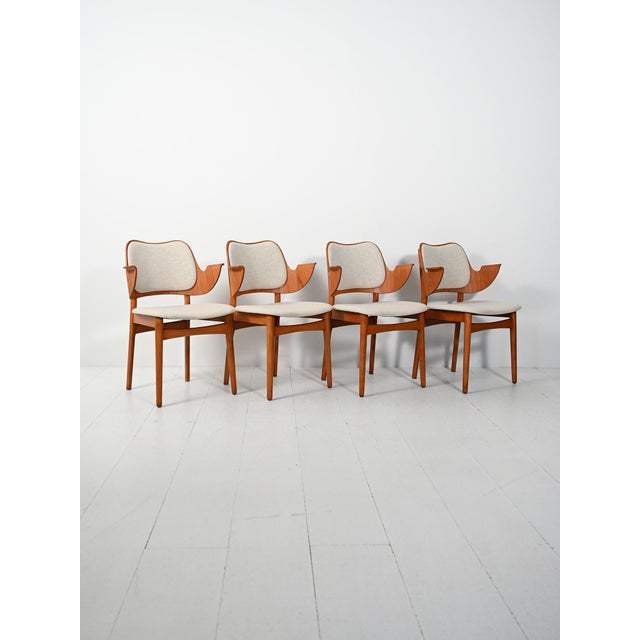 Set of four "Model 107" teak chairs designed by Hans Olsen, with curved armrests and newly reupholstered cushions. Set of...