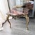 An exceptional vintage Italian side table with a striking burgundy marble top and an intricately relief-decorated brass...