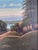 This original vintage oil painting, created around 1960, shows a tree-lined coastal promenade leading towards the sea. The...