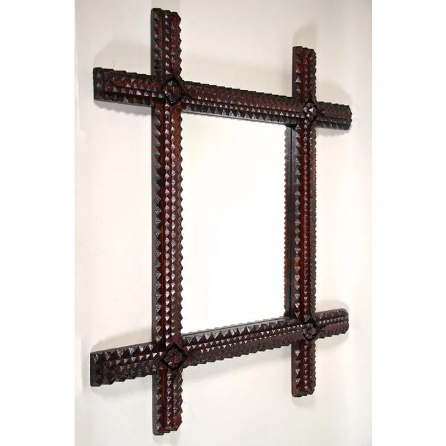 Unusual rustic Tramp Art wall mirror from the late 19th century around 1870 in Austria. Hand carved out of fine basswood,...