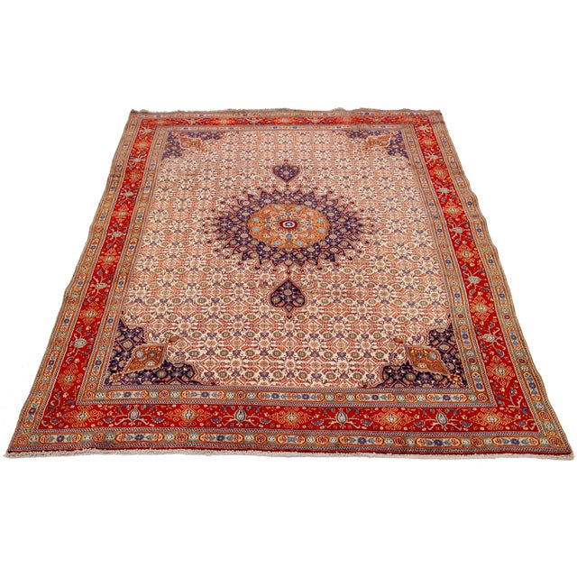 This hand-knotted wool rug has a beige field with multicolor accents in an overall design. This rug measures 6'7'' x 9'5''.