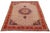 This hand-knotted wool rug has a beige field with multicolor accents in an overall design. This rug measures 6'7'' x 9'5''.