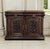 A 19th century French Renaissance Revival buffet hand carved from rich walnut, glowing with a deep, warm patina that only...