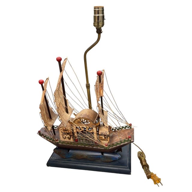 This charming vintage table lamp features an intricately handcrafted model of a traditional Chinese junk boat set atop a...