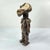 This finely carved wooden figure with Kaolin (clay) painted on its face originates from the Zimba people of the Democratic...