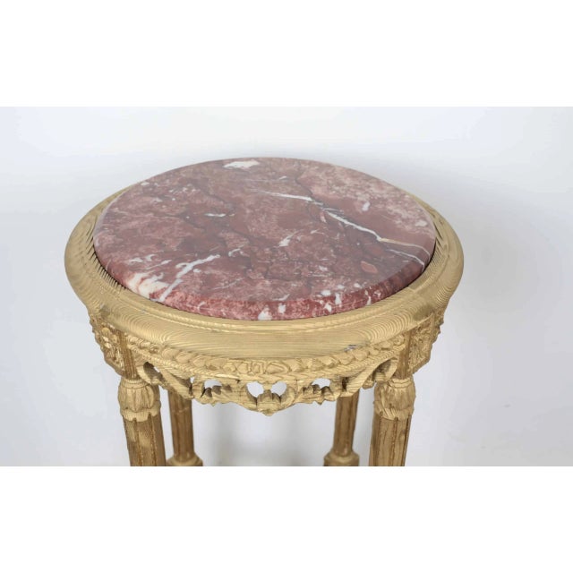 A taller side table in the classicist style of Louis XVI. The table is made of solid wood, hand-carved and turned, the...