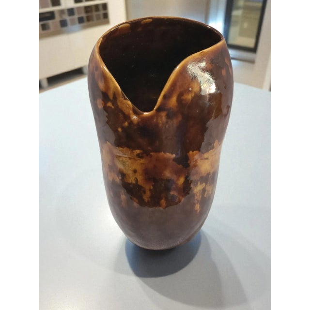 This Mid-Century Modern Art Glazed Studio Pottery Brown Vase is a beautifully handmade piece of abstract art pottery from...