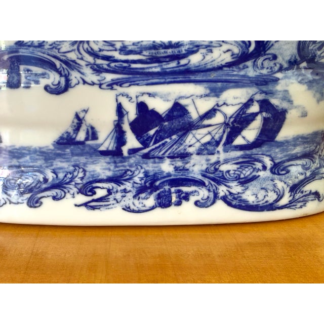 A beautiful blue and white porcelain foot bath featuring a nautical ship motif and handles on each end. Circa 1980s. Most...