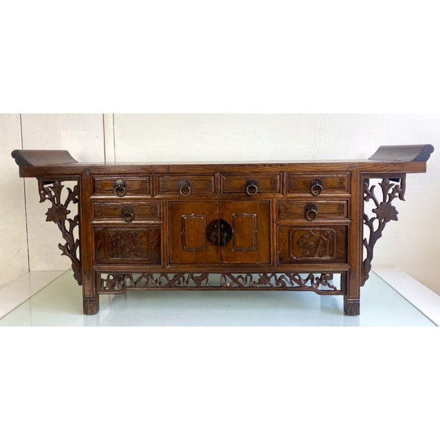 A charming and charcterfull small Chinese altar coffer from carved Elmwood. The curved edges and carved apron of this...