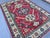 This bold Karachov Kazak rug features three large octagonal medallions stacked vertically on ivory grounds, each centered...