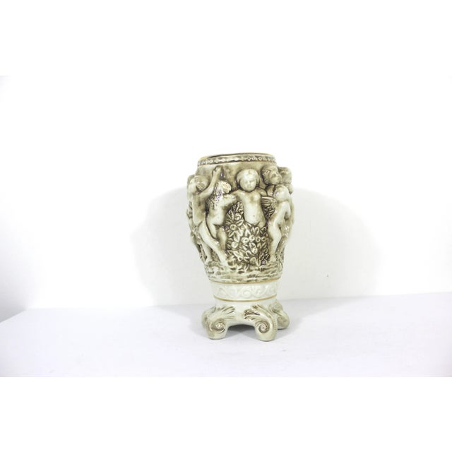 Large porcelain figural R. Capodimonte Italian vase with putti or cherubs in relief. This is a white base with a sepia...