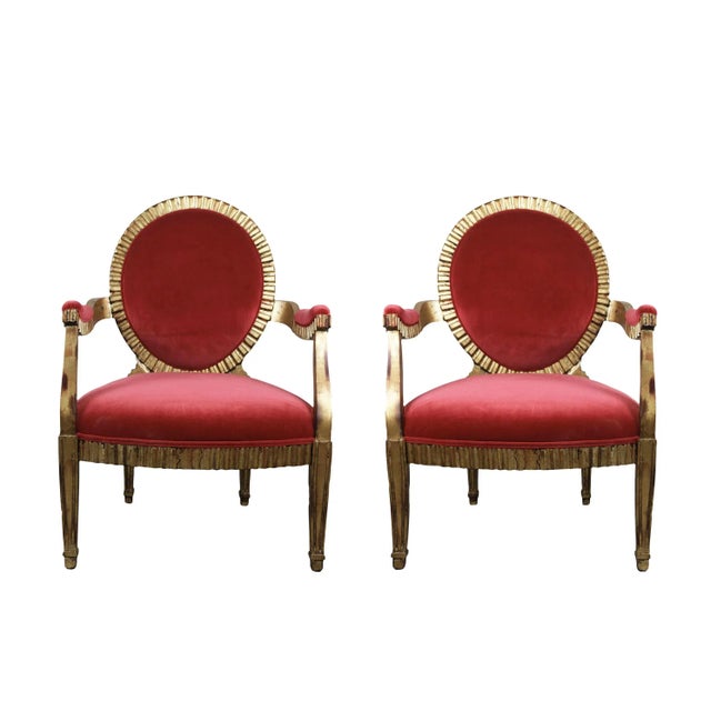 Pair of French Louis XVI style gilt carved wood Fauteuils (armchairs). Featuring an elegantly carved wooden frame with a...