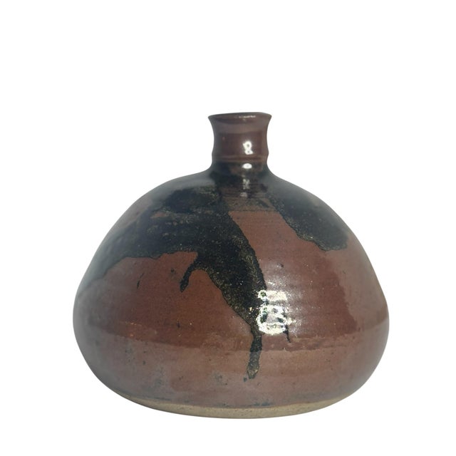 A handsome piece of American studio pottery in the wabi-sabi tradition. The form is a low, dome-shouldered vessel with a...