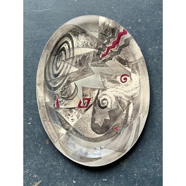 This monumental original studio pottery platter is a striking masterclass in Postmodern abstraction, offering an...