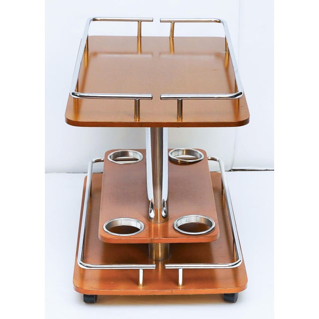 A fine Italian Mid-Century Modern bar cart or drinks trolley, featuring a rectangular two-tier design of wood and chrome,...