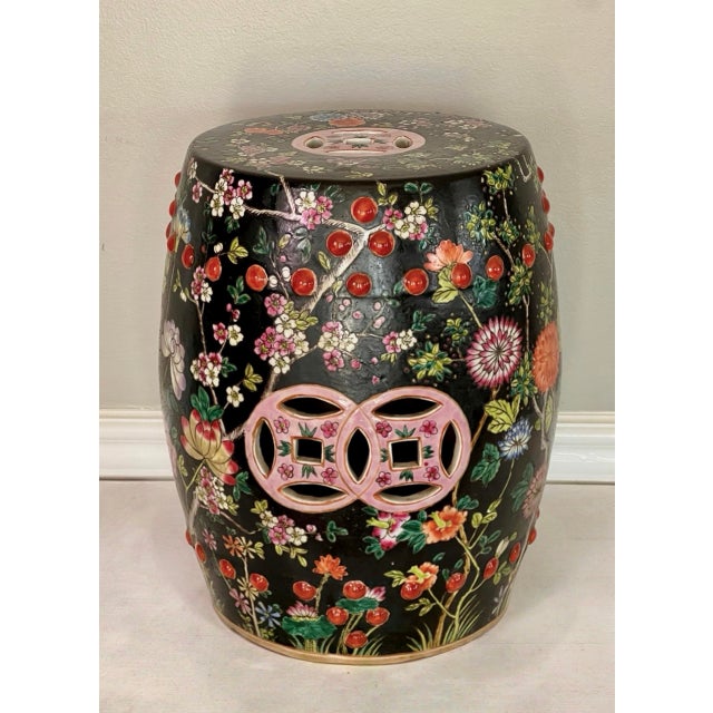 Classic barrel form porcelain Chinese garden seat in Famille Noir, circa 1910. A special stool or side table featuring a...