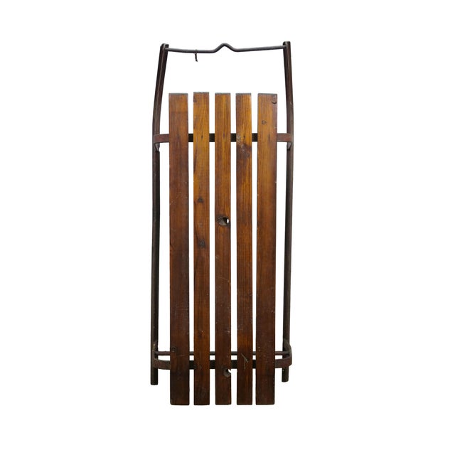 This vintage snow sled features an elongated, minimalist design anchored by a durable seat platform crafted from four...