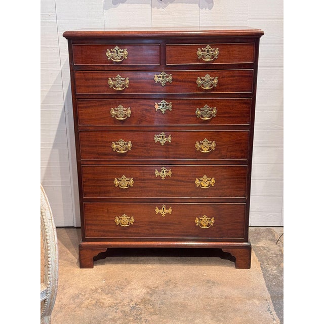 A tall 19th century chest in well figured mahogany, fitted with two short drawers over five long graduated drawers, each...