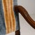 This piece presents as a armchair, distinguished by dark wood frame, blue/gold striped upholstery. It was made in France...
