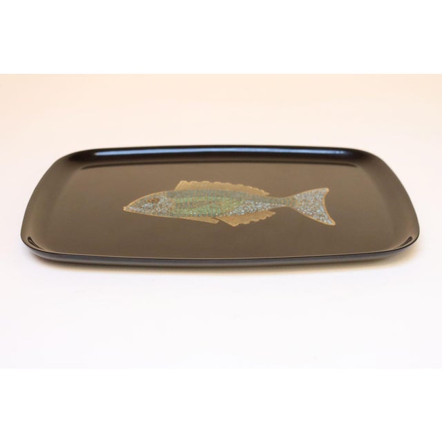 Decorative tray by Couroc of Monterey, California with an inlaid fish motif (circa 1960s). Composed of a black lacquer...