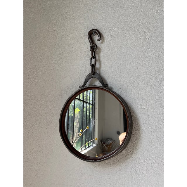 Vintage large and thick metal mirror with its hanging chain, dating from the 1950s. Inspired by Brutalist design, its...