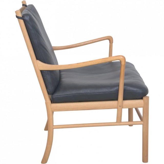 Ole Wanscher Colonial chair with a frame of ash and cushions upholstered in black leather. The chair is from the 2000s and...