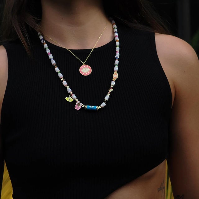 Brighten your day with the Cheerful Neon Pink Evil Eye & Diamond Pendant Gold Chain Necklace. This playful pendant,...