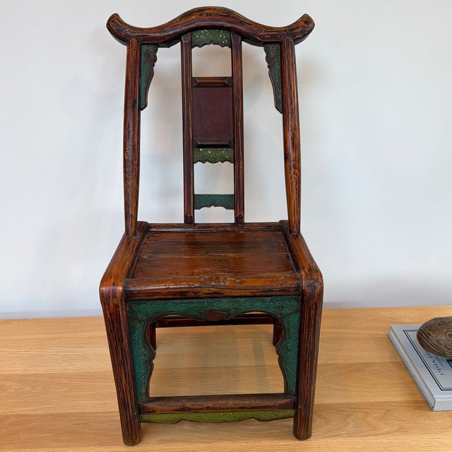 Charming antique Chinese child’s chair featuring a beautifully shaped yoke-style back in a wonderfully aged wood finish...