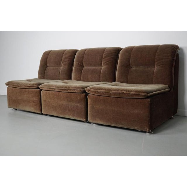 This modular sofa was made in Germany in the 1970s. It features three elements covered in brown / green velvet fabric...
