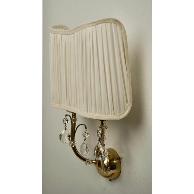 A pair of brass wall lights made in Austria from the 1930's . The brass frames have been completely restored with the...