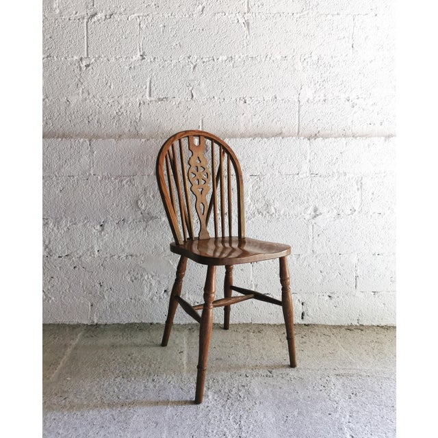 This set of four antique dining chairs, crafted from solid oak, dates back to the early 20th century. These elegant...