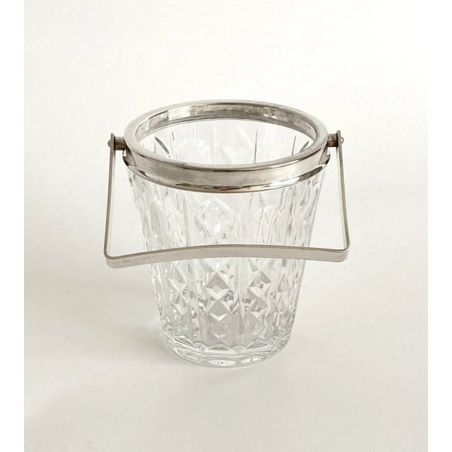 1980s glass ice bucket featuring a silverplate rim and handle made in Italy with marks for William Adams. Suitable for its...