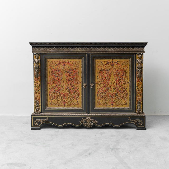 French sideboard. Wooden frame with hand-painted decorations and brass details. Consisting of 3 doors and 3 internal...