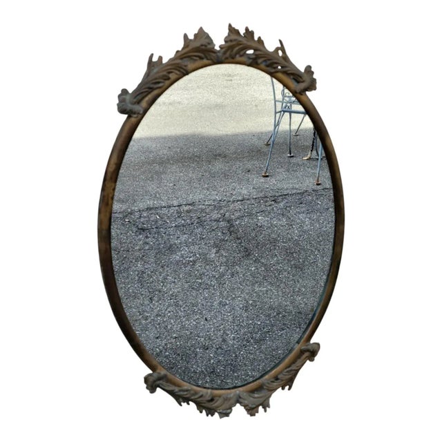 Original 1930 Italian solid brass oval wall mirror featuring a finely detailed decorative frame. The brass has its...