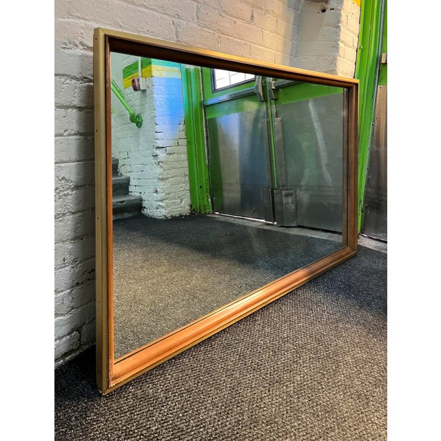 One beautiful and large cherry wood with brass border mirror by John Widdicomb 1950s (signed). This elegant mirror is...